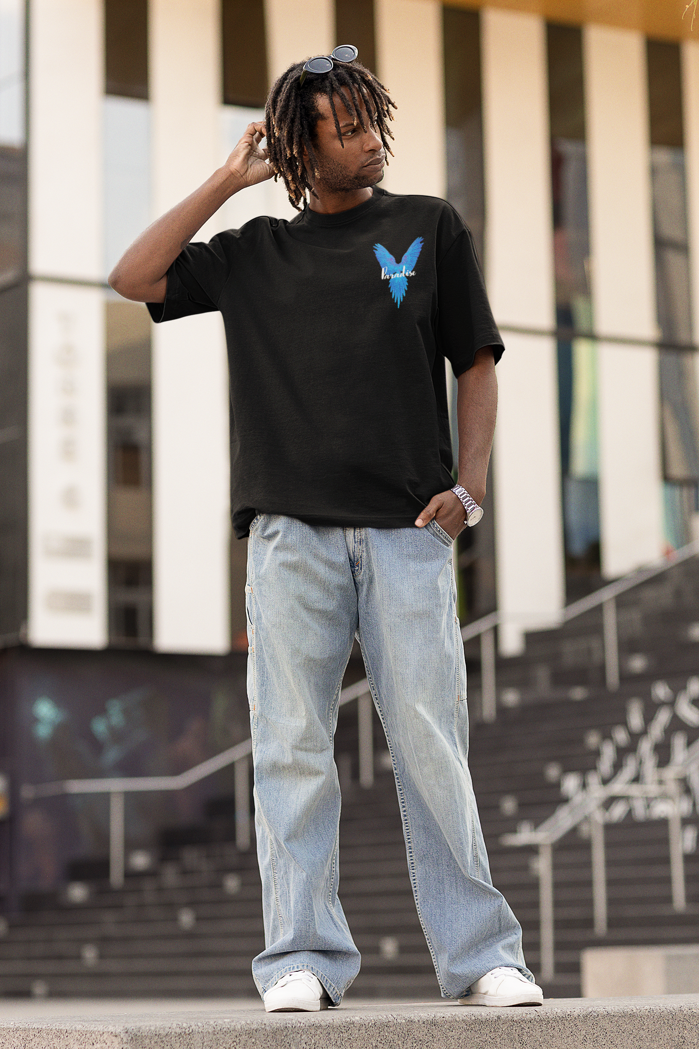 Model wearing W.I.F.I Men's Oversized "Paradise Blue Wings" Graphic T-Shirt in a casual setting front look