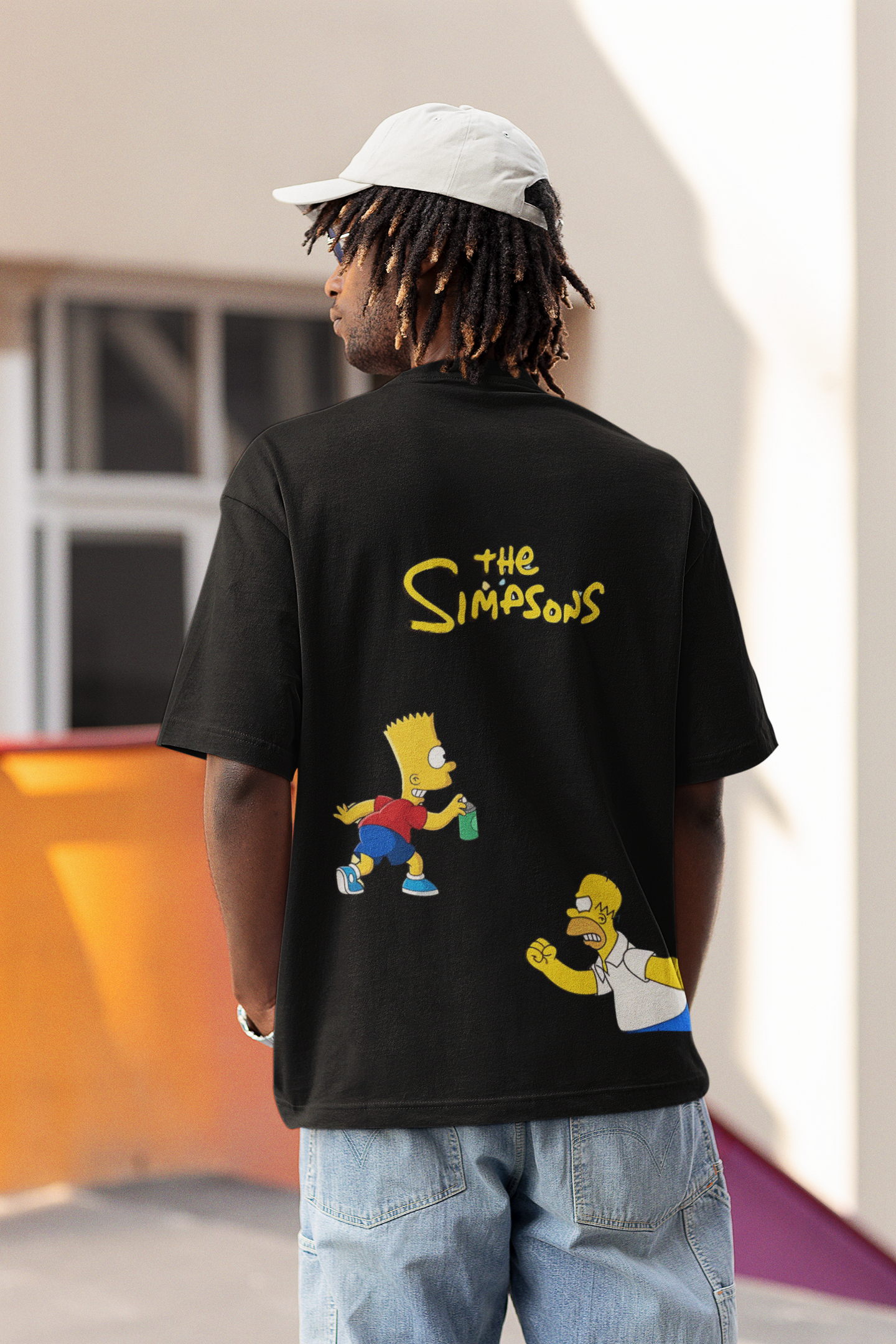 Model wearing W.I.F.I Men's Oversized "The Simpsons" Graphic Black T-Shirt styled with jeans for a casual look.