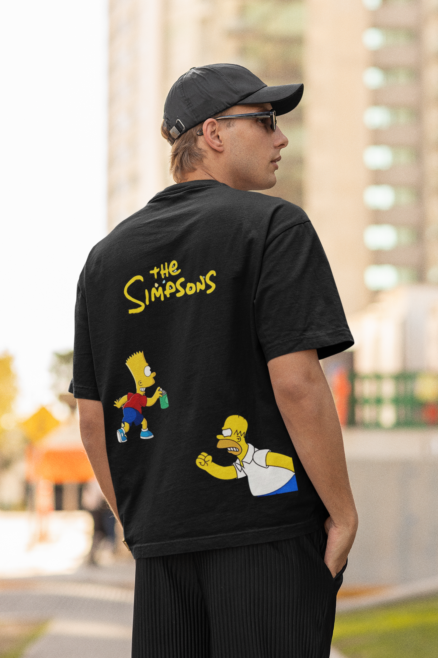 Model wearing W.I.F.I Men's Oversized "The Simpsons" Graphic Black T-Shirt styled with jeans for a casual look.